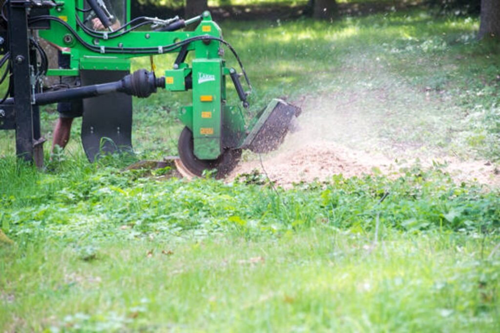 Stump grinding equipment removing a tree stump from a residential yard in Stow, OH